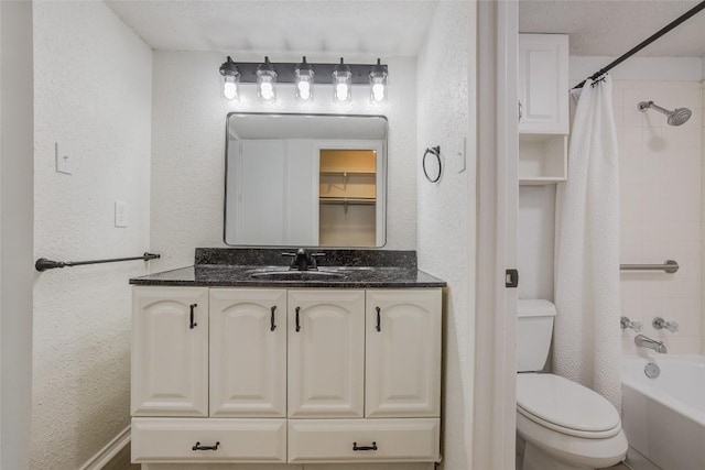 8600 Fathom Cir Unit 1303, Austin, TX 78750 - bathroom featuring toilet, vanity, a textured wall, and shower / bathtub combination with curtain