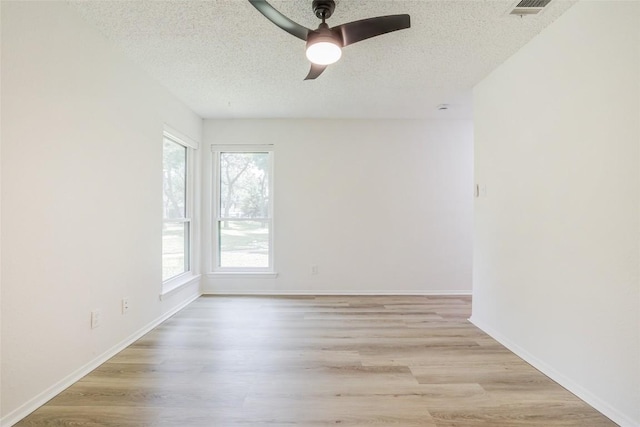 8600 Fathom Cir Unit 1303, Austin, TX 78750 - unfurnished room with a textured ceiling, a ceiling fan, and light wood-type flooring