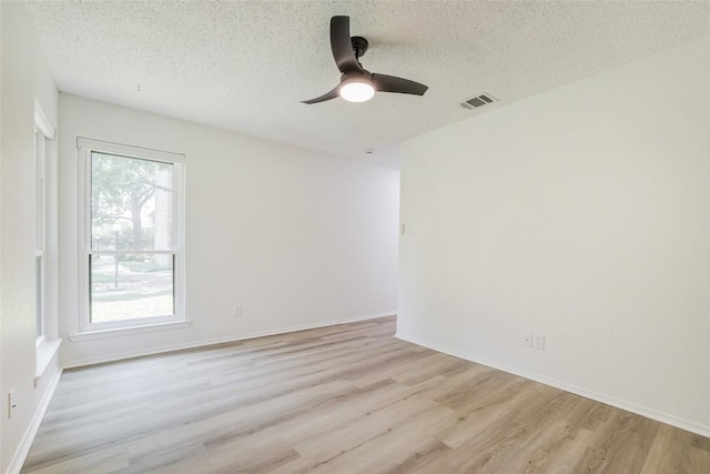 8600 Fathom Cir Unit 1303, Austin, TX 78750 - empty room with a textured ceiling, light wood-style floors, and ceiling fan