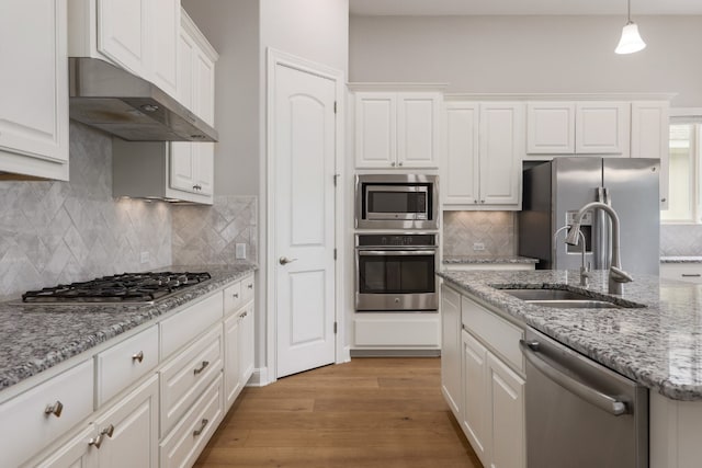 3324 Venezia Vw, Leander, TX 78641 - kitchen with stainless steel appliances, a sink, white cabinetry, and under cabinet range hood