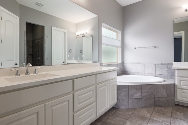 3324 Venezia Vw, Leander, TX 78641 - full bath featuring a bath, double vanity, tile patterned flooring, and a tile shower