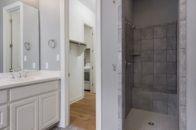 3324 Venezia Vw, Leander, TX 78641 - bathroom featuring tiled shower, vanity, and wood finished floors