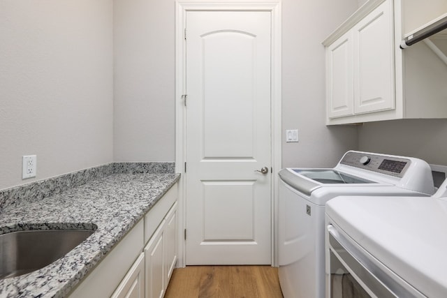 3324 Venezia Vw, Leander, TX 78641 - laundry room featuring washer and dryer, cabinet space, and light wood finished floors