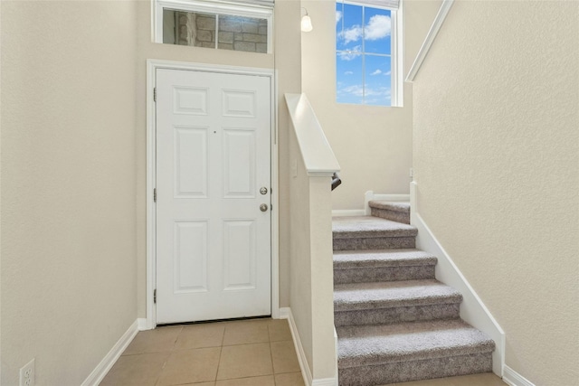 4203 Birdwatch Loop Unit 14, Pflugerville, TX 78660 - entrance foyer with stairway, a textured wall, and light tile patterned floors