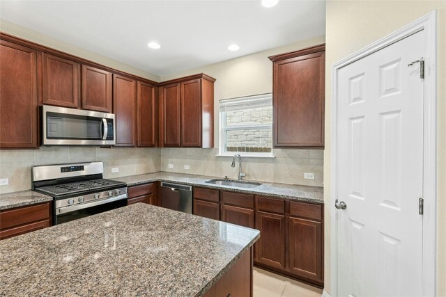4203 Birdwatch Loop Unit 14, Pflugerville, TX 78660 - kitchen with appliances with stainless steel finishes, stone countertops, decorative backsplash, and recessed lighting