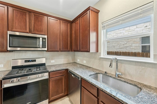 4203 Birdwatch Loop Unit 14, Pflugerville, TX 78660 - kitchen with stainless steel appliances, light stone countertops, and tasteful backsplash