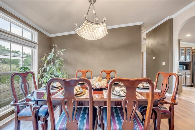7500 Muleshoe Bend Trl, Marble Falls, TX 78654 - dining room with a chandelier, arched walkways, crown molding, light wood-type flooring, and baseboards