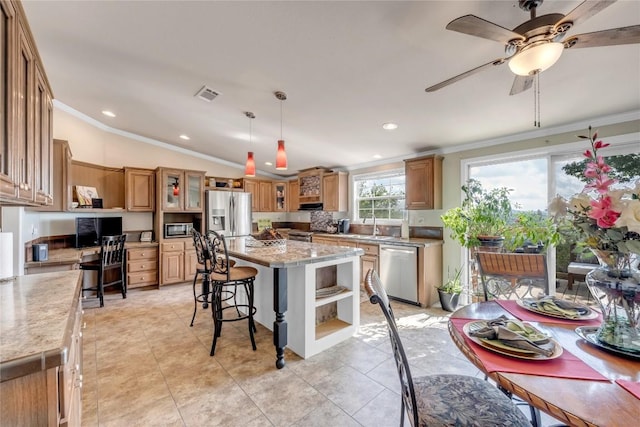 7500 Muleshoe Bend Trl, Marble Falls, TX 78654 - kitchen featuring stainless steel appliances, ornamental molding, open shelves, a center island, and a kitchen bar