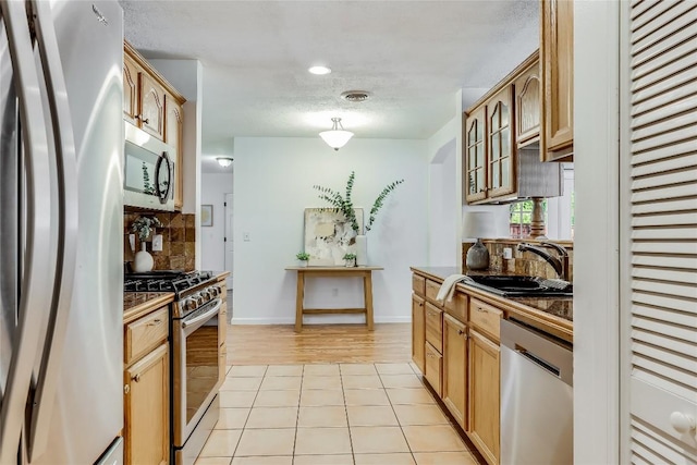 1505 Wheless Ln, Austin, TX 78723 - kitchen featuring appliances with stainless steel finishes, tasteful backsplash, light tile patterned flooring, and recessed lighting
