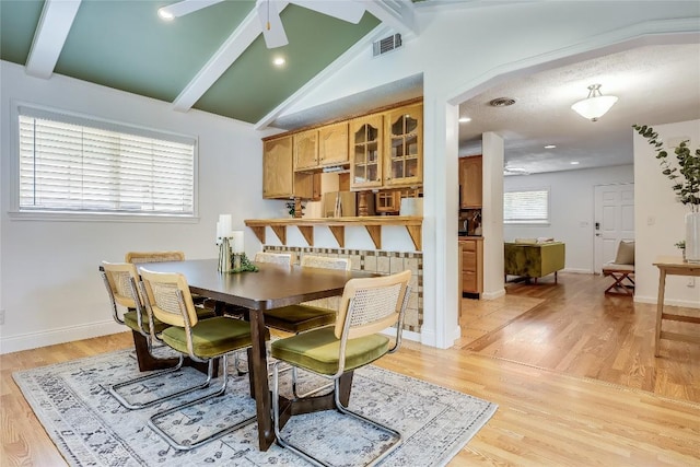 1505 Wheless Ln, Austin, TX 78723 - dining space with light wood-style flooring, ceiling fan, and arched walkways