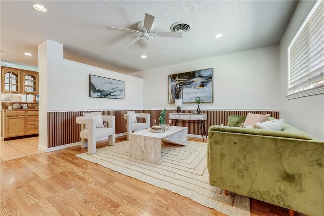 1505 Wheless Ln, Austin, TX 78723 - living room with wainscoting, a ceiling fan, recessed lighting, light wood-style flooring, and a textured ceiling