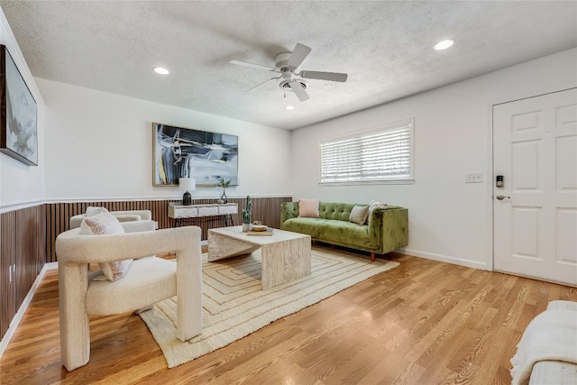 1505 Wheless Ln, Austin, TX 78723 - living room with a textured ceiling, a ceiling fan, light wood finished floors, recessed lighting, and wainscoting