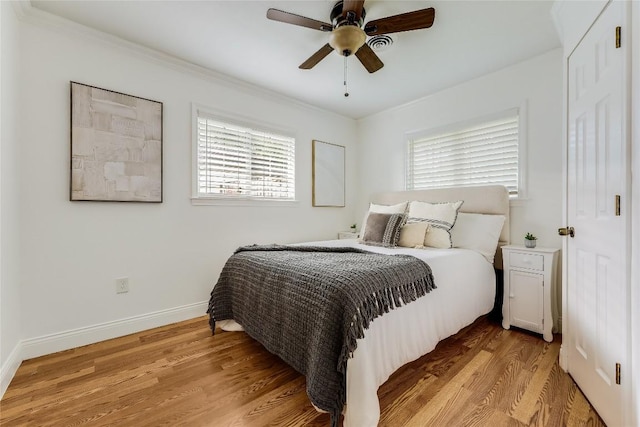 1505 Wheless Ln, Austin, TX 78723 - bedroom with light wood finished floors, a ceiling fan, and crown molding
