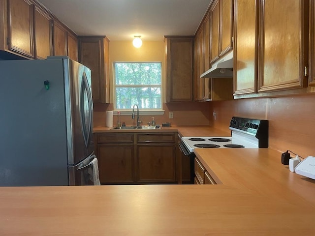 309 Stolle Ln, Flatonia, TX 78941 - kitchen with freestanding refrigerator, a sink, under cabinet range hood, electric range oven, and light countertops