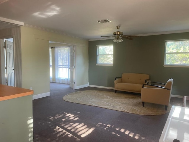 309 Stolle Ln, Flatonia, TX 78941 - living area featuring crown molding, ceiling fan, and carpet flooring