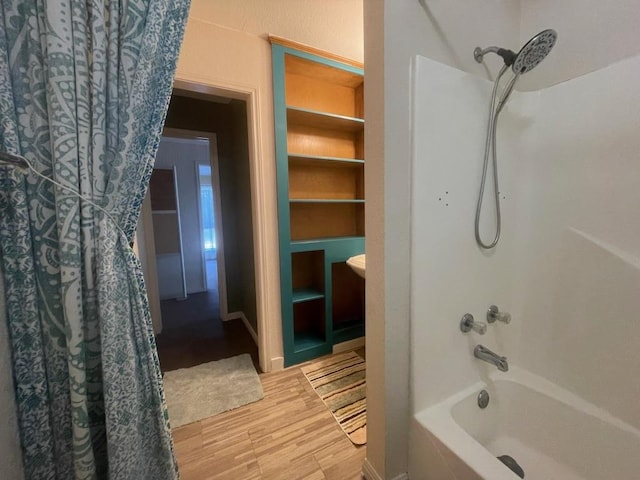 309 Stolle Ln, Flatonia, TX 78941 - bathroom with shower / tub combo with curtain and wood finished floors