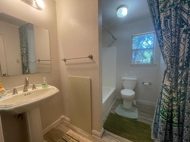 309 Stolle Ln, Flatonia, TX 78941 - bathroom featuring wood finished floors and shower / tub combo