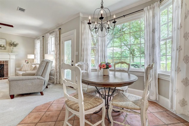 303 Rio Bravo Rd, Georgetown, TX 78628 - dining area with healthy amount of natural light, a chandelier, ornamental molding, a fireplace, and baseboards