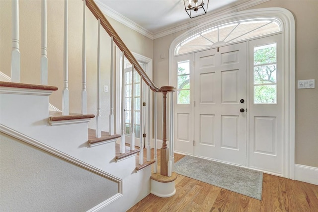 303 Rio Bravo Rd, Georgetown, TX 78628 - entryway with stairs, wood finished floors, healthy amount of natural light, and crown molding
