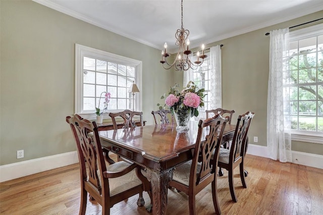 303 Rio Bravo Rd, Georgetown, TX 78628 - dining space featuring a chandelier, light wood-type flooring, baseboards, and crown molding