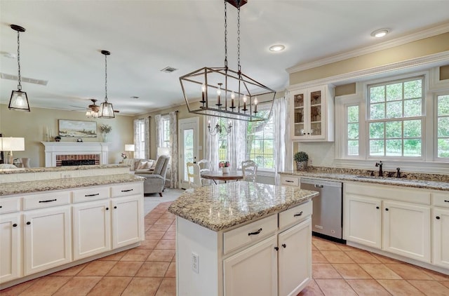 303 Rio Bravo Rd, Georgetown, TX 78628 - kitchen featuring dishwasher, plenty of natural light, a chandelier, light tile patterned floors, and ornamental molding