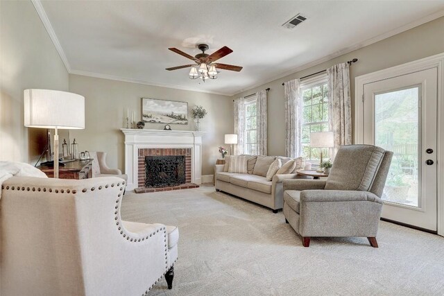303 Rio Bravo Rd, Georgetown, TX 78628 - living room with light carpet, crown molding, ceiling fan, a brick fireplace, and baseboards