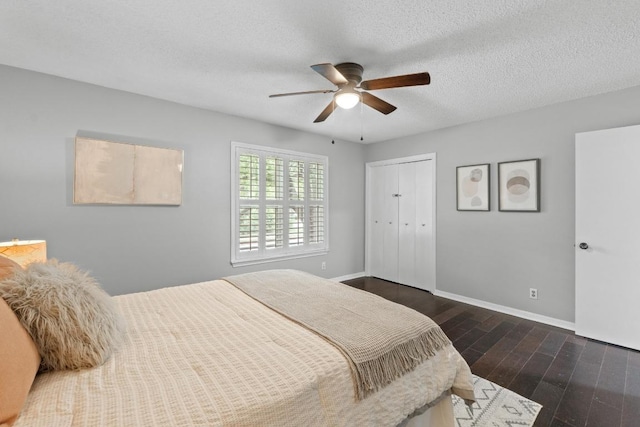 6109 Bullard Dr Unit A, Austin, TX 78757 - bedroom with dark wood-type flooring, a closet, a ceiling fan, and a textured ceiling