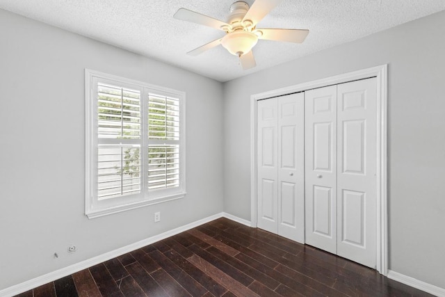 6109 Bullard Dr Unit A, Austin, TX 78757 - unfurnished bedroom with dark wood-style flooring, a textured ceiling, a closet, and ceiling fan