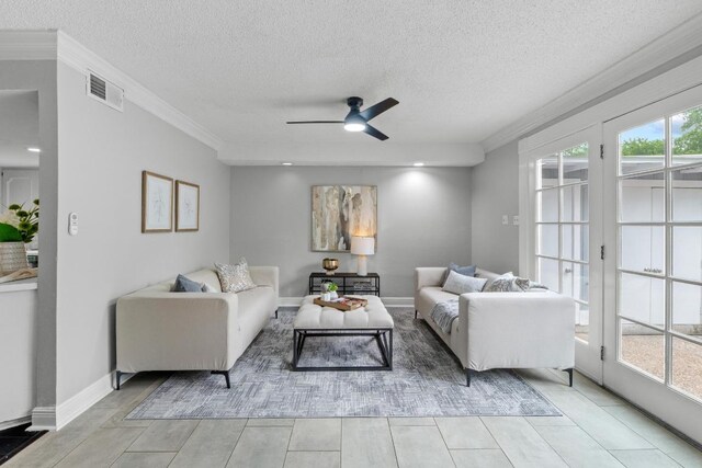 6109 Bullard Dr Unit A, Austin, TX 78757 - living area featuring ornamental molding, a ceiling fan, and a textured ceiling