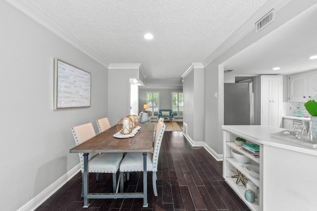 6109 Bullard Dr Unit A, Austin, TX 78757 - dining area featuring a textured ceiling, dark wood-type flooring, and crown molding