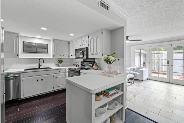 6109 Bullard Dr Unit A, Austin, TX 78757 - kitchen with black appliances, a textured ceiling, open shelves, french doors, and light countertops