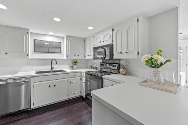 6109 Bullard Dr Unit A, Austin, TX 78757 - kitchen featuring black appliances, light countertops, white cabinetry, dark wood-style flooring, and recessed lighting