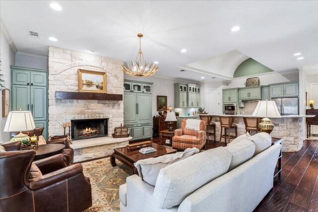 9122 Balcones Club Dr Unit 9, Austin, TX 78750 - living area with crown molding, dark wood-style flooring, a chandelier, recessed lighting, and a stone fireplace