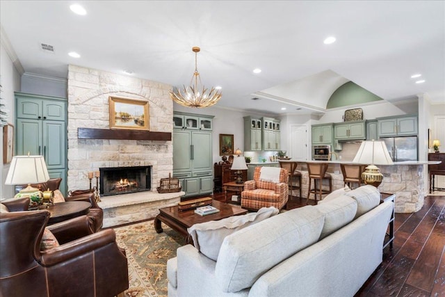 9122 Balcones Club Dr Unit 9, Austin, TX 78750 - living area featuring ornamental molding, dark wood finished floors, a chandelier, recessed lighting, and a fireplace