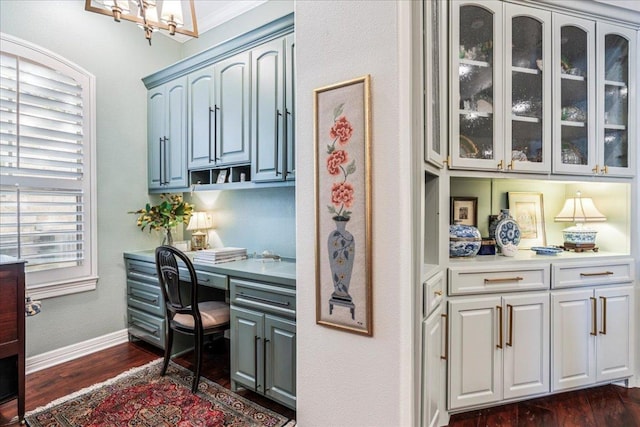 9122 Balcones Club Dr Unit 9, Austin, TX 78750 - office space featuring built in desk, dark wood-type flooring, a chandelier, and baseboards