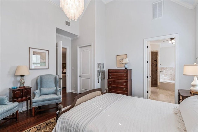 9122 Balcones Club Dr Unit 9, Austin, TX 78750 - bedroom with ornamental molding, a high ceiling, baseboards, a chandelier, and ensuite bathroom