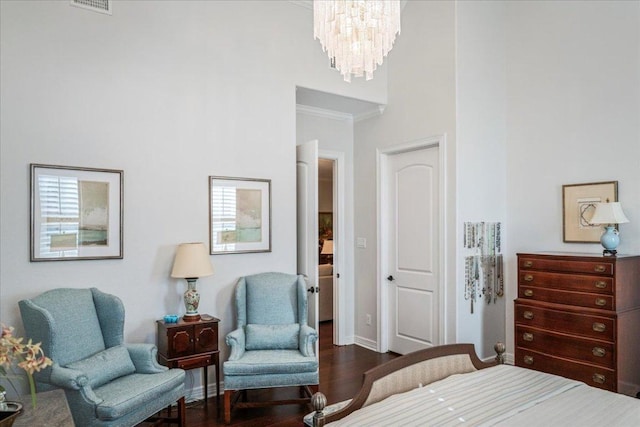 9122 Balcones Club Dr Unit 9, Austin, TX 78750 - bedroom featuring a chandelier, dark wood-style flooring, crown molding, a towering ceiling, and baseboards