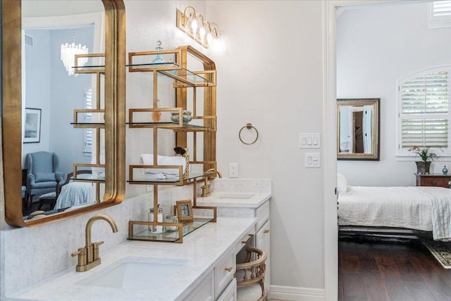 9122 Balcones Club Dr Unit 9, Austin, TX 78750 - ensuite bathroom with double vanity and hardwood / wood-style flooring
