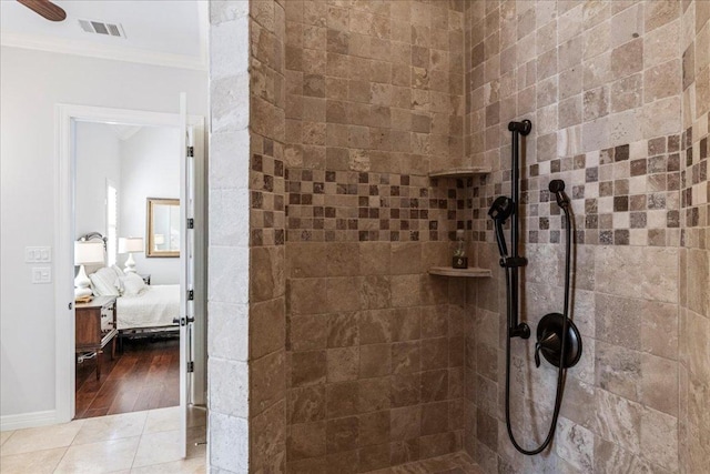 9122 Balcones Club Dr Unit 9, Austin, TX 78750 - bathroom with ornamental molding, ensuite bath, tiled shower, and tile patterned floors
