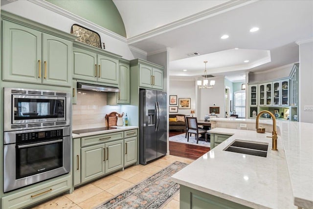 9122 Balcones Club Dr Unit 9, Austin, TX 78750 - kitchen with green cabinets, stainless steel appliances, a sink, crown molding, and a chandelier