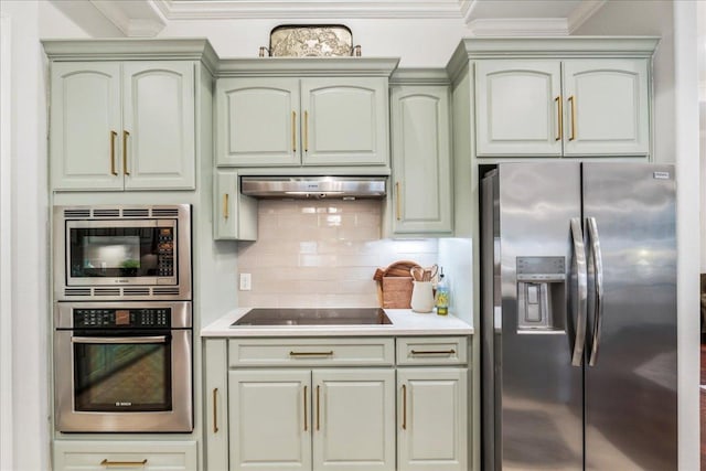 9122 Balcones Club Dr Unit 9, Austin, TX 78750 - kitchen with stainless steel appliances, crown molding, under cabinet range hood, decorative backsplash, and light countertops