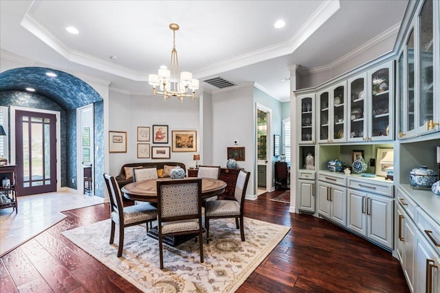 9122 Balcones Club Dr Unit 9, Austin, TX 78750 - dining room featuring a chandelier, dark wood-type flooring, crown molding, baseboards, and a raised ceiling