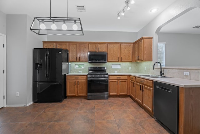 2009 Campfield Pkwy, Austin, TX 78745 - kitchen with freestanding refrigerator, stainless steel microwave, range with gas stovetop, dishwashing machine, and a sink