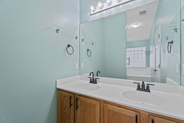 2009 Campfield Pkwy, Austin, TX 78745 - full bathroom with a textured wall, double vanity, and a shower with shower door