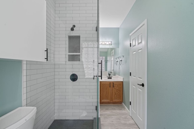 2009 Campfield Pkwy, Austin, TX 78745 - bathroom featuring a shower stall, vanity, toilet, and wood finished floors