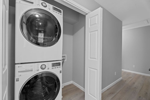 2009 Campfield Pkwy, Austin, TX 78745 - washroom with stacked washer / drying machine, light wood-style floors, and baseboards