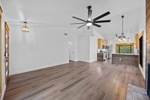 16202 Kicking Bird Dr, Leander, TX 78641 - unfurnished living room featuring a chandelier, ceiling fan, a fireplace, dark wood-type flooring, and high vaulted ceiling