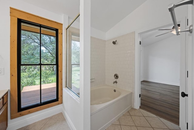 16202 Kicking Bird Dr, Leander, TX 78641 - bathroom featuring lofted ceiling, tile patterned flooring, bathtub / shower combination, vanity, and baseboards