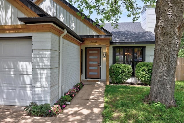 16202 Kicking Bird Dr, Leander, TX 78641 - property entrance featuring a shingled roof, a garage, and a chimney