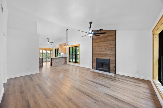 16202 Kicking Bird Dr, Leander, TX 78641 - unfurnished living room featuring a ceiling fan, a large fireplace, baseboards, and high vaulted ceiling